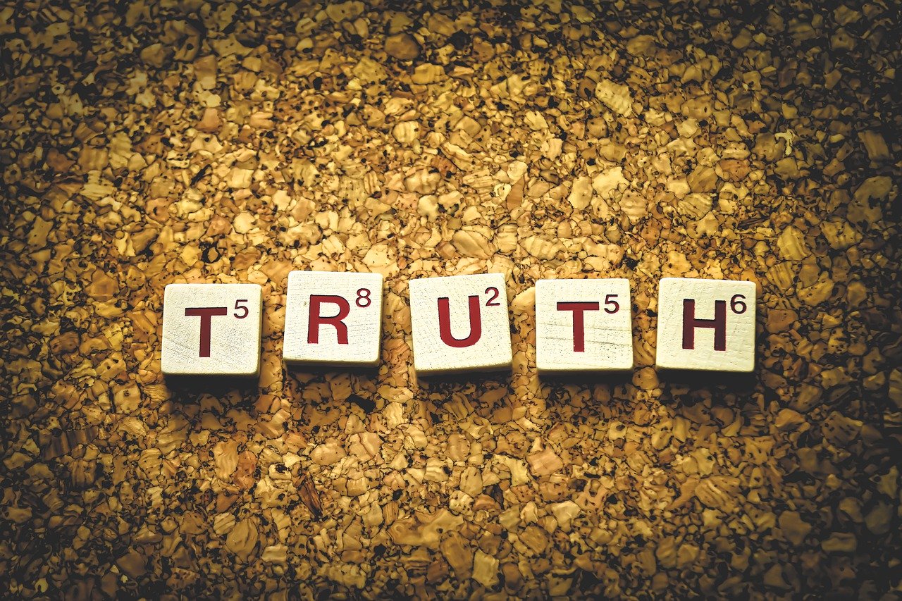 The word "Truth" spelled out with letter tiles